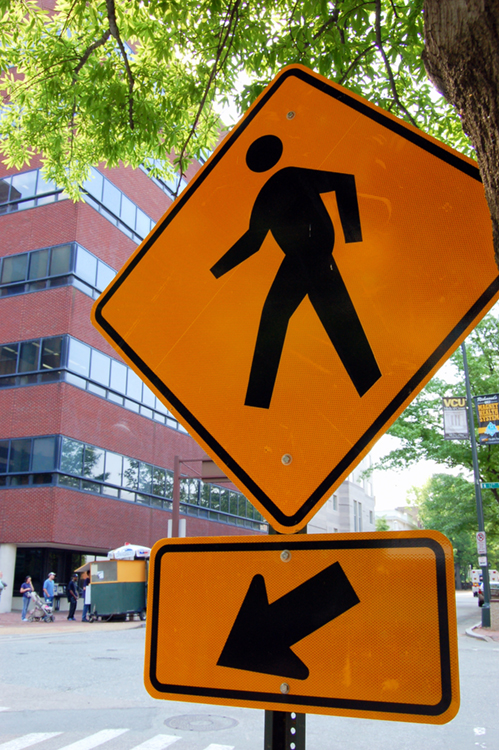 The photo (a) shows a sign of a pedestrian crossing and an arrow.