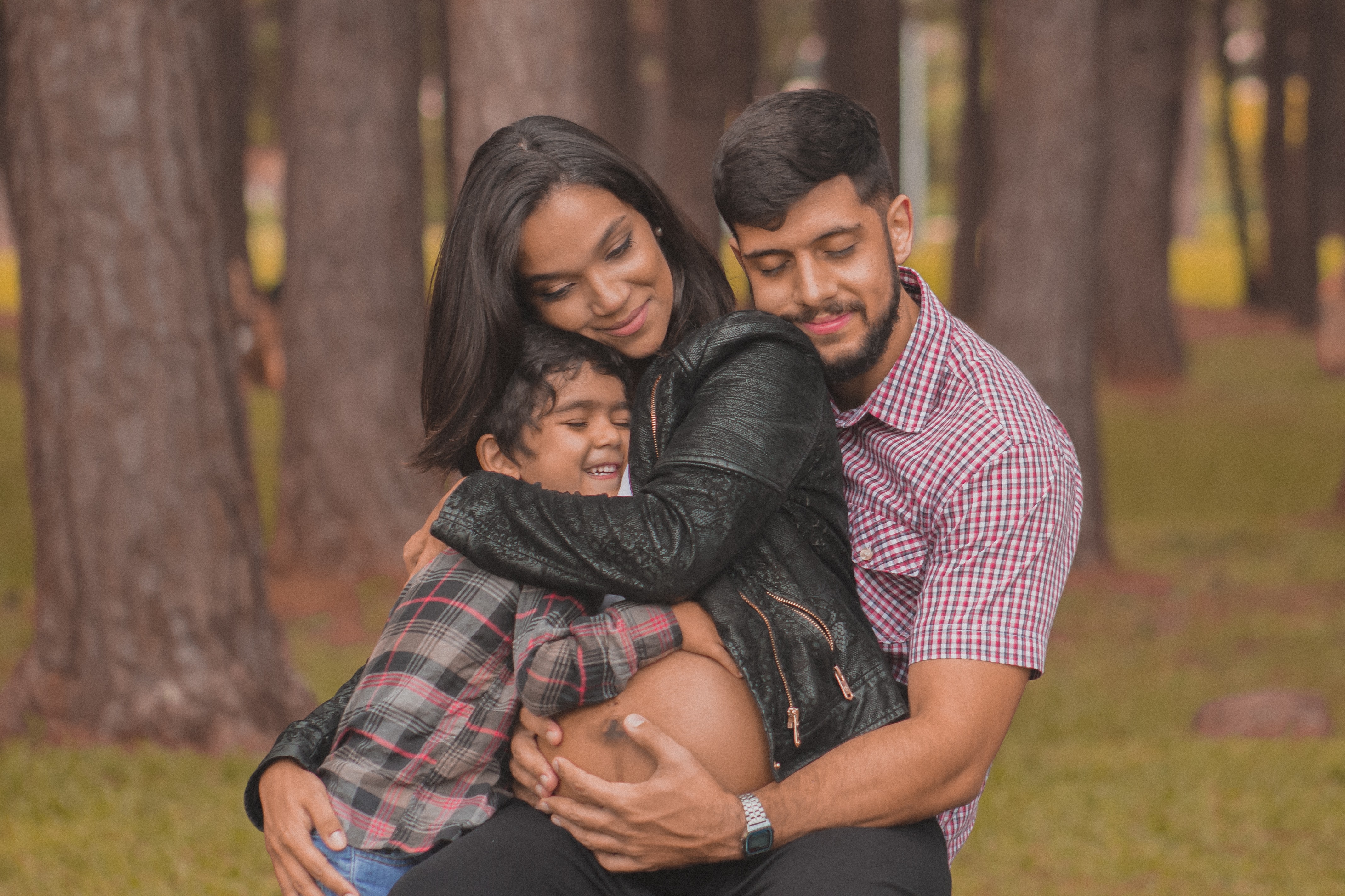 Image shows a family hugging; dad, son and pregnant mom.Retrieved from https://unsplash.com/photos/JYJxLjvIGWY