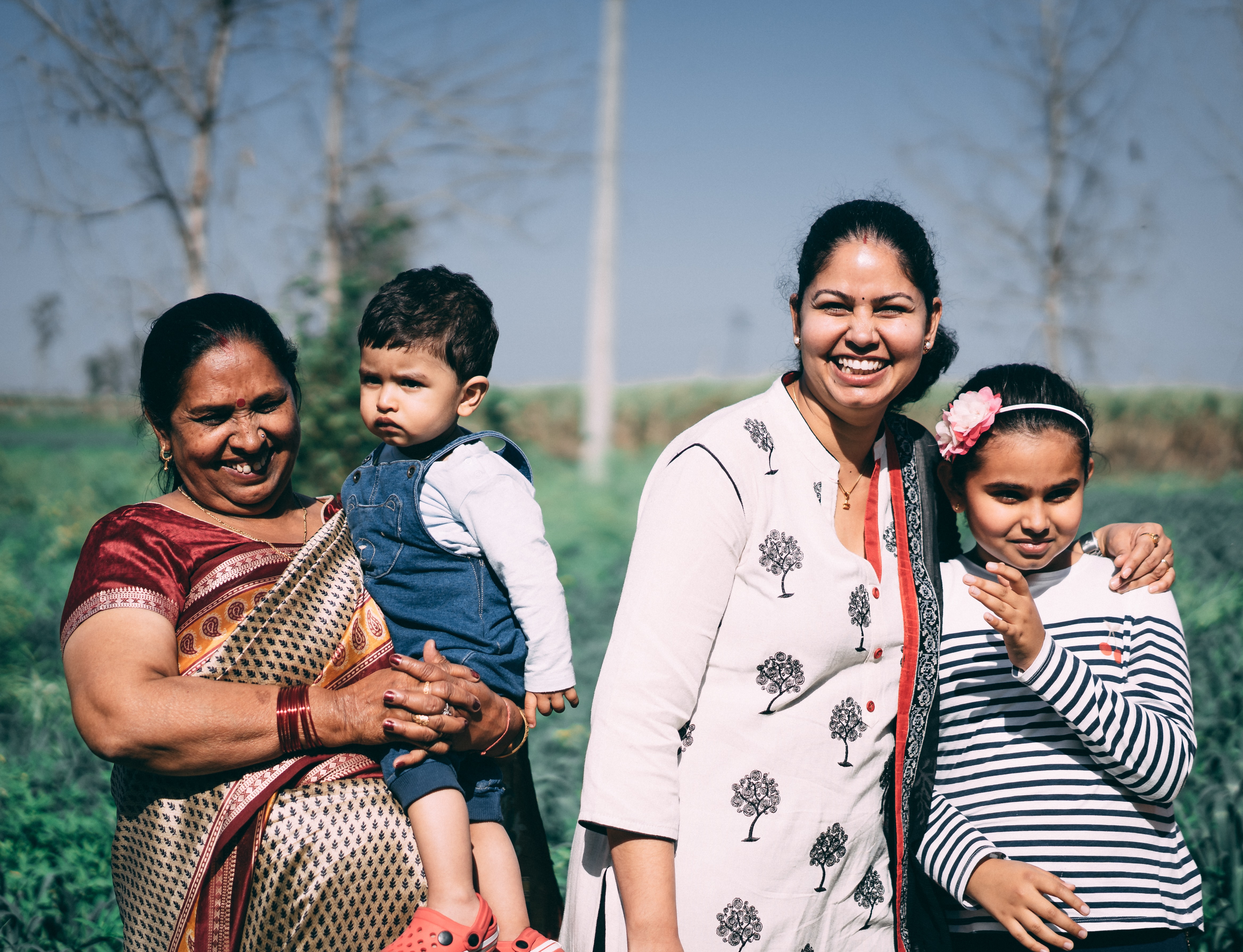 Image shows a photo of a family: Grandma, Mom, son, daughter Retrieved from https://unsplash.com/photos/GmDVGjqeVEk