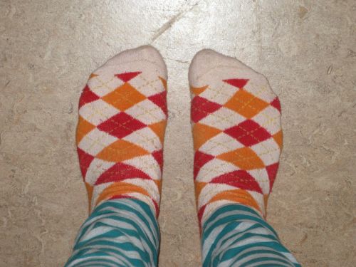 Green striped leggings with red and yellow argyle socks.