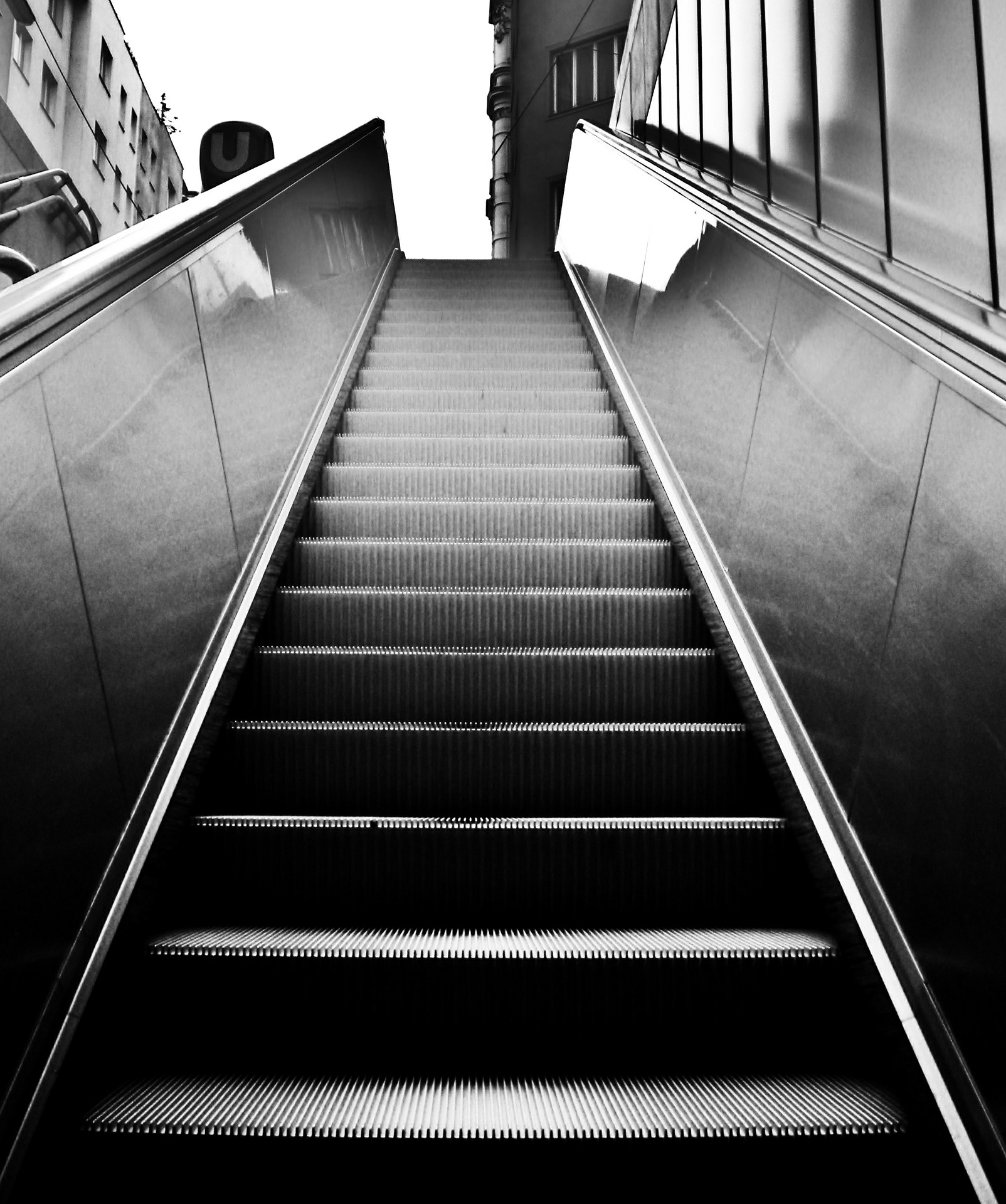 A black-and-white photo of an escalator.