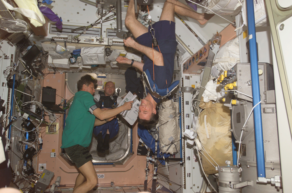 The figure shows some astronauts floating inside the International Space Station