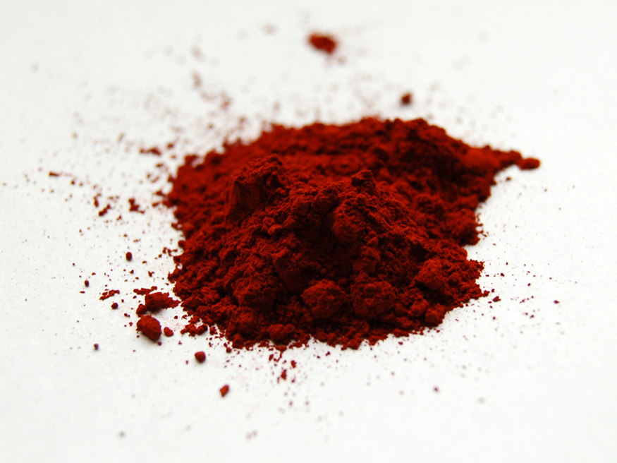 The image shows fluorescent dye sample in red powder form.